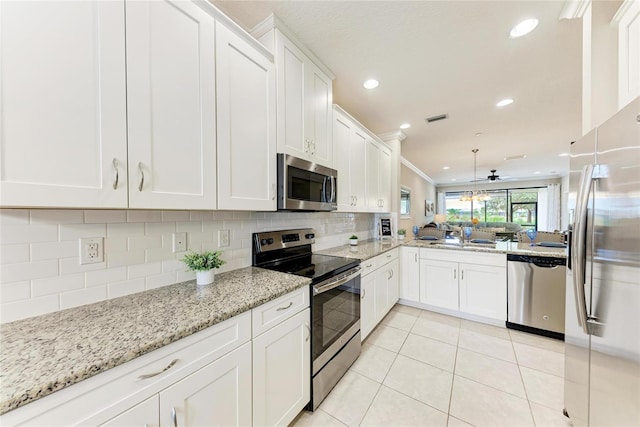 13711 Messina Loop Unit 102, Lakewood Ranch, FL 34211 - kitchen featuring appliances with stainless steel finishes, light tile patterned floors, backsplash, white cabinetry, and recessed lighting