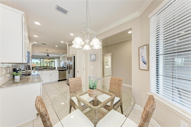 13711 Messina Loop Unit 102, Lakewood Ranch, FL 34211 - dining area with crown molding, light tile patterned floors, a chandelier, recessed lighting, and baseboards