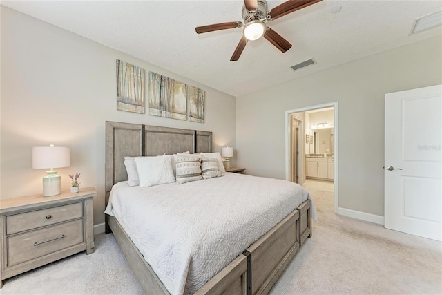 13711 Messina Loop Unit 102, Lakewood Ranch, FL 34211 - bedroom with light colored carpet, baseboards, ensuite bath, and ceiling fan