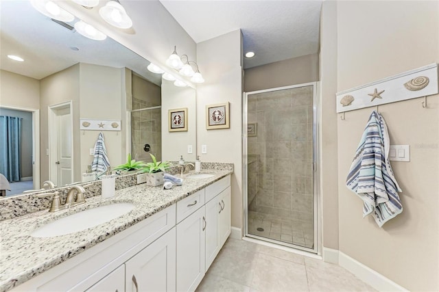 13711 Messina Loop Unit 102, Lakewood Ranch, FL 34211 - full bath with double vanity, a stall shower, tile patterned floors, and baseboards
