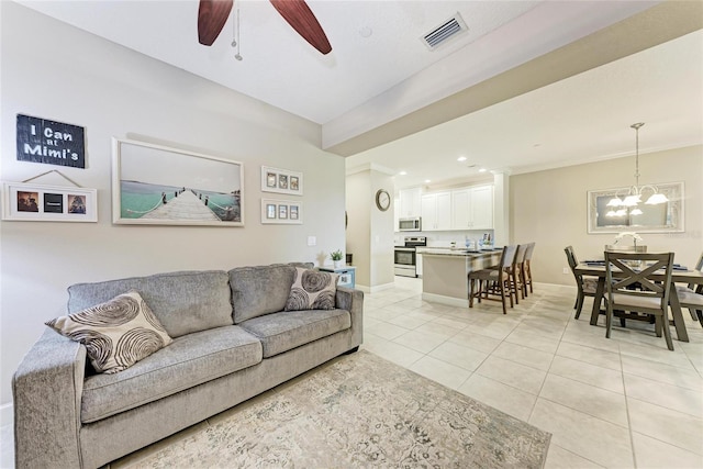 13711 Messina Loop Unit 102, Lakewood Ranch, FL 34211 - living room featuring light tile patterned floors, a ceiling fan, baseboards, a chandelier, and recessed lighting