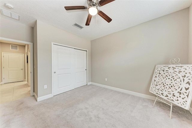13711 Messina Loop Unit 102, Lakewood Ranch, FL 34211 - unfurnished bedroom with light colored carpet, baseboards, a closet, and ceiling fan