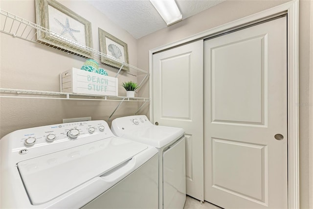 13711 Messina Loop Unit 102, Lakewood Ranch, FL 34211 - laundry room featuring separate washer and dryer and a textured ceiling