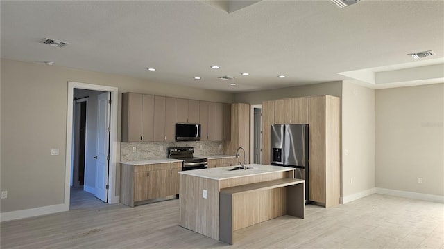 2323 Zuyder Ter, North Port, FL 34286 - kitchen with appliances with stainless steel finishes, a sink, baseboards, light wood-style floors, and backsplash
