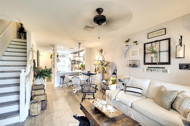 4727 Sabal Key Dr Unit 4727, Bradenton, FL 34203 - living area featuring stairs, wood finished floors, and ceiling fan