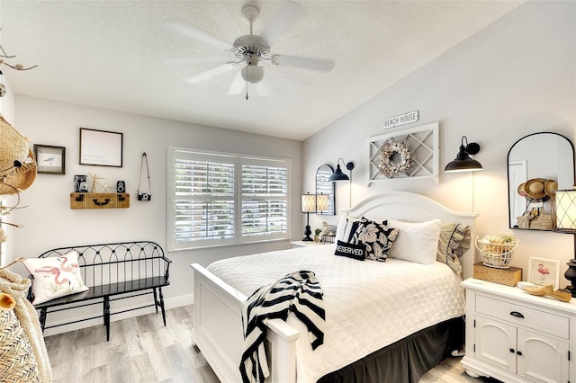 4727 Sabal Key Dr Unit 4727, Bradenton, FL 34203 - bedroom with light wood-style floors, a textured ceiling, ceiling fan, and vaulted ceiling