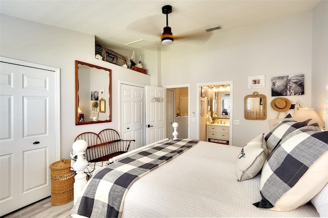 4727 Sabal Key Dr Unit 4727, Bradenton, FL 34203 - bedroom with light wood finished floors, a towering ceiling, ceiling fan, connected bathroom, and a closet