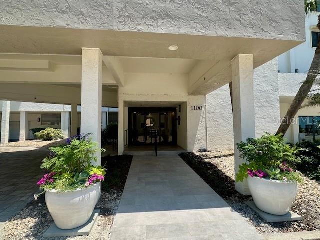 1100 Benjamin Franklin Dr Unit 802, Sarasota, FL 34236 - property entrance with stucco siding
