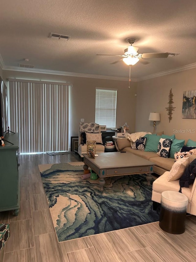 9808 Campanula Ct, Land O Lakes, FL 34637 - living area featuring ornamental molding, a ceiling fan, wood finish floors, and a textured ceiling