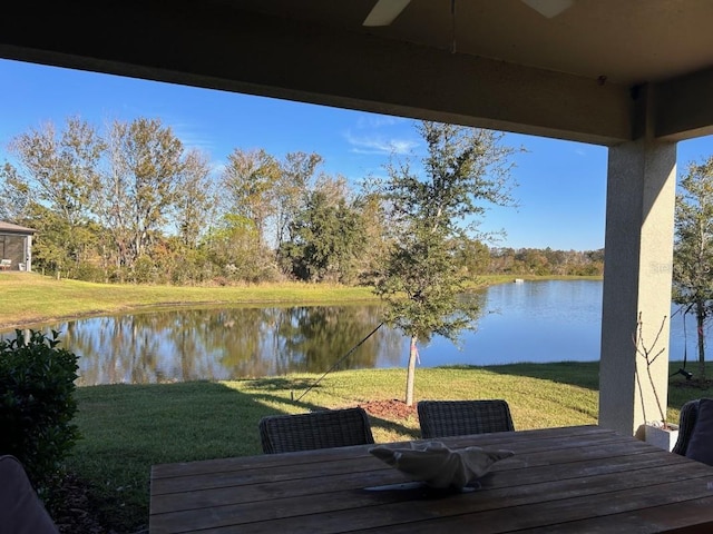 9808 Campanula Ct, Land O Lakes, FL 34637 - deck with a water view, a yard, outdoor dining space, and a ceiling fan