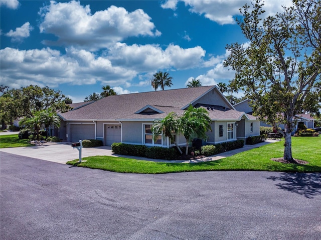 1612 Fairway Oaks Dr, Palmetto, FL 34221 - ranch-style house with a front lawn, an attached garage, driveway, stucco siding, and roof with shingles