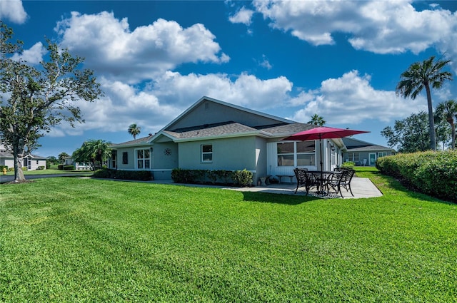 1612 Fairway Oaks Dr, Palmetto, FL 34221 - rear view of property with a patio area, a yard, and stucco siding