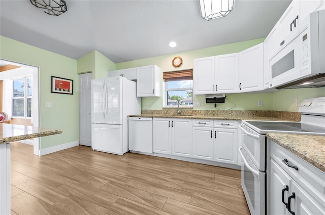 1612 Fairway Oaks Dr, Palmetto, FL 34221 - kitchen with white appliances, a sink, light wood-style floors, white cabinets, and recessed lighting