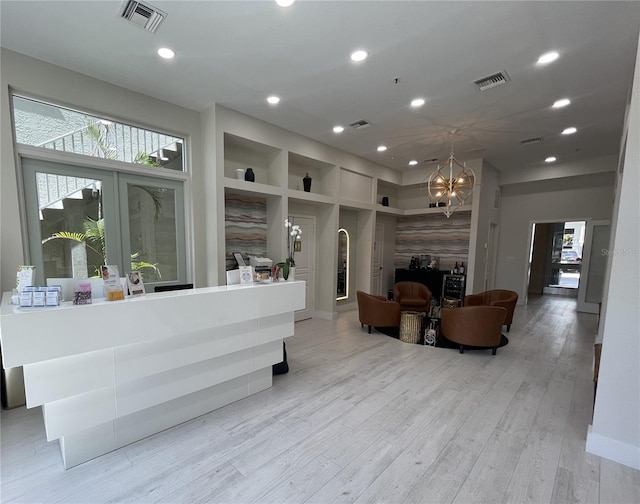 1345 2nd St, Sarasota, FL 34236 - living room with a chandelier, plenty of natural light, recessed lighting, arched walkways, and light wood-style flooring