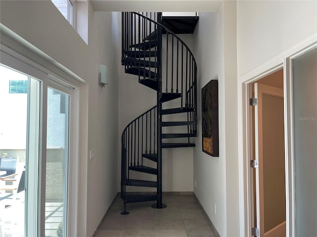 1345 2nd St, Sarasota, FL 34236 - stairway with a high ceiling, plenty of natural light, tile patterned floors, and baseboards