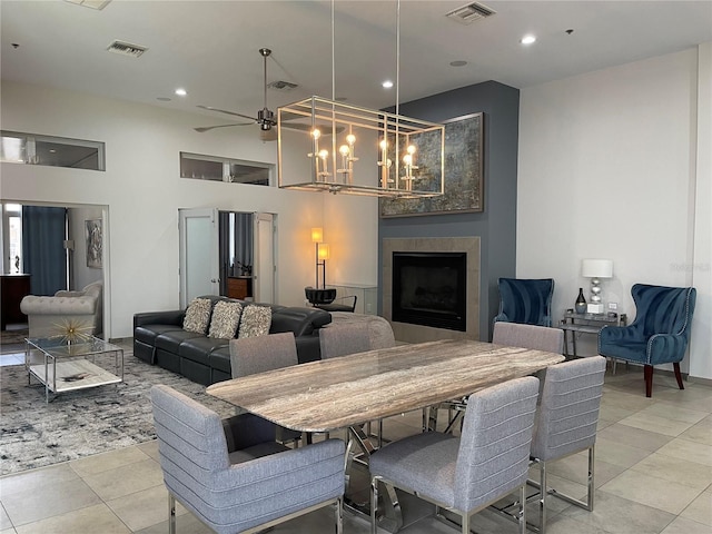 1345 2nd St, Sarasota, FL 34236 - dining area featuring a fireplace, a ceiling fan, light tile patterned flooring, a chandelier, and recessed lighting