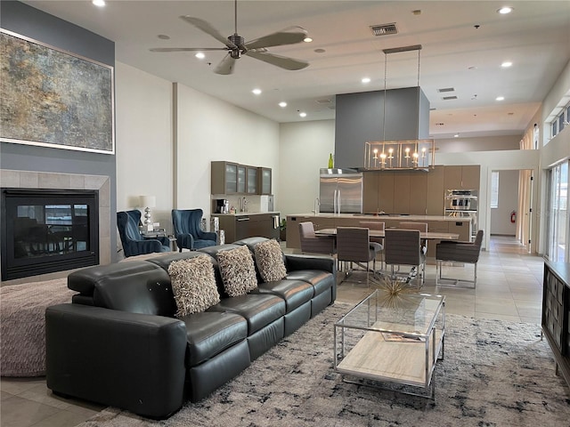 1345 2nd St, Sarasota, FL 34236 - living area featuring a chandelier, light tile patterned floors, a tile fireplace, recessed lighting, and ceiling fan