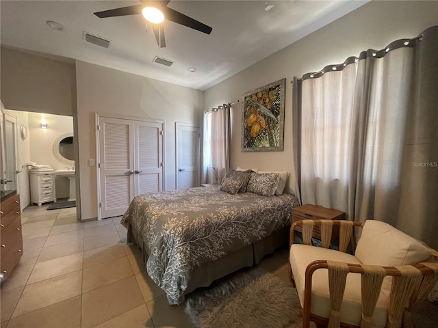 1345 2nd St, Sarasota, FL 34236 - bedroom featuring light tile patterned flooring, ceiling fan, connected bathroom, and multiple closets