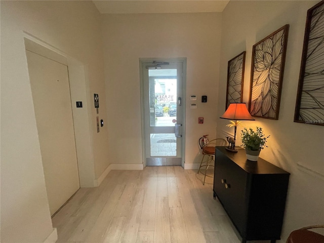 1345 2nd St, Sarasota, FL 34236 - entrance foyer featuring light wood finished floors, elevator, and baseboards