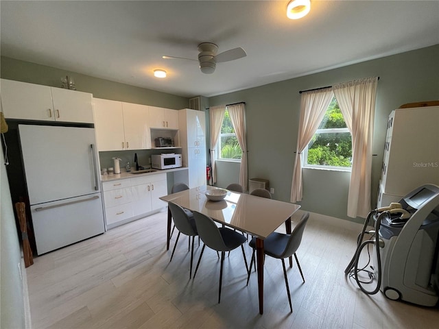 1345 2nd St, Sarasota, FL 34236 - dining area featuring a ceiling fan, light wood-style flooring, and healthy amount of natural light