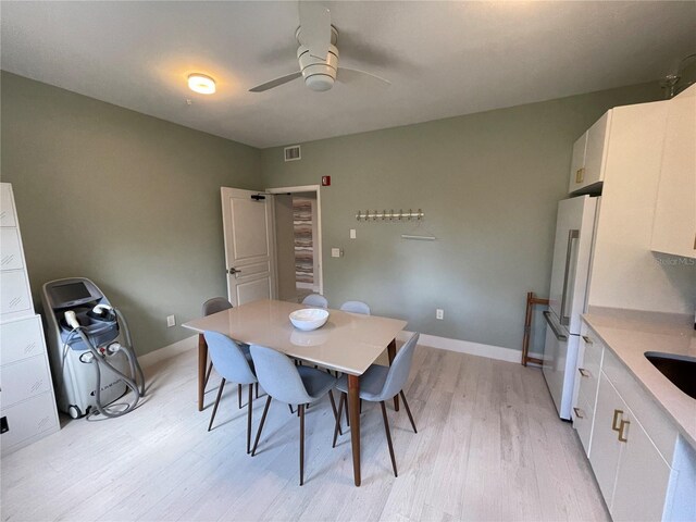 1345 2nd St, Sarasota, FL 34236 - dining room with light wood finished floors, a ceiling fan, and baseboards