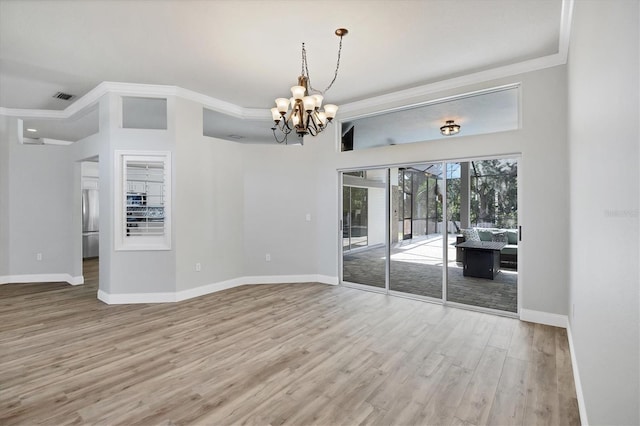 9016 30th St E, Parrish, FL 34219 - empty room featuring a chandelier, ornamental molding, wood finished floors, and baseboards