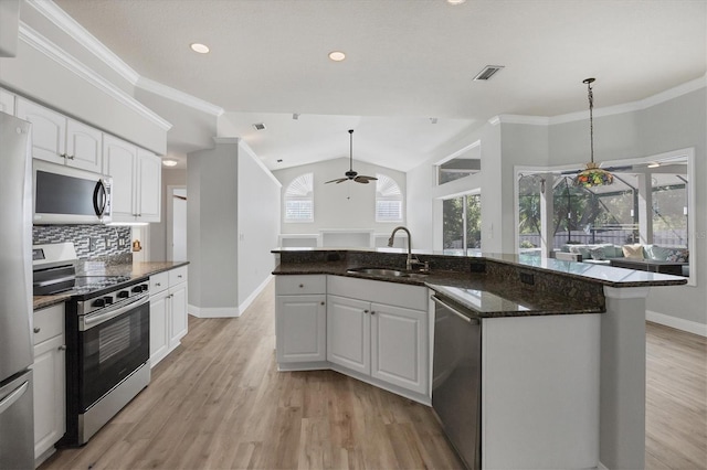 9016 30th St E, Parrish, FL 34219 - kitchen featuring a sink, appliances with stainless steel finishes, ceiling fan, baseboards, and light wood-type flooring