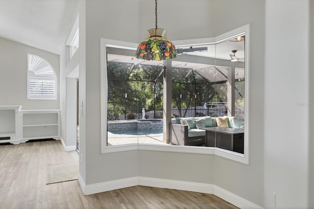 9016 30th St E, Parrish, FL 34219 - unfurnished dining area with wood finished floors, baseboards, and a sunroom