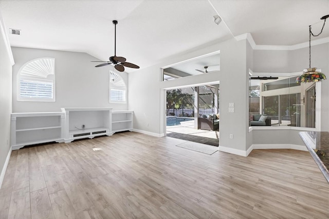 9016 30th St E, Parrish, FL 34219 - unfurnished living room with a ceiling fan, wood finished floors, baseboards, lofted ceiling, and a sunroom