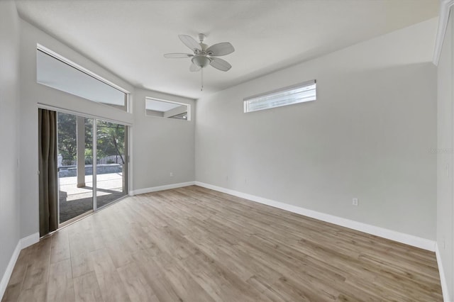 9016 30th St E, Parrish, FL 34219 - empty room with wood finished floors, a ceiling fan, and baseboards