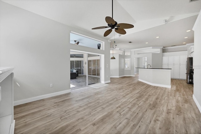 9016 30th St E, Parrish, FL 34219 - unfurnished living room featuring ceiling fan, light wood-style floors, high vaulted ceiling, recessed lighting, and baseboards