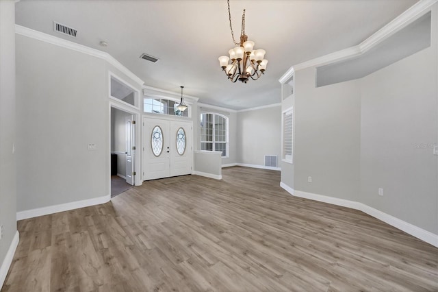 9016 30th St E, Parrish, FL 34219 - entryway featuring a chandelier, ornamental molding, baseboards, and wood finished floors