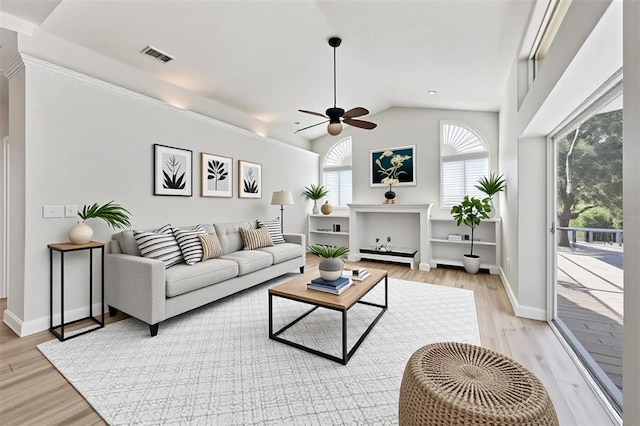 9016 30th St E, Parrish, FL 34219 - living room featuring a ceiling fan, light wood-style flooring, lofted ceiling, and baseboards