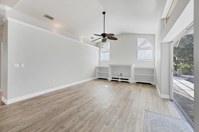 9016 30th St E, Parrish, FL 34219 - unfurnished living room featuring plenty of natural light, a ceiling fan, light wood-style flooring, baseboards, and vaulted ceiling