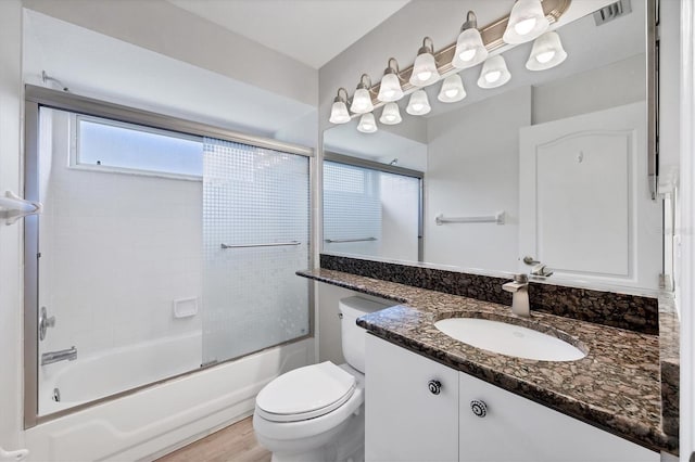 9016 30th St E, Parrish, FL 34219 - bathroom with vanity, toilet, and enclosed tub / shower combo