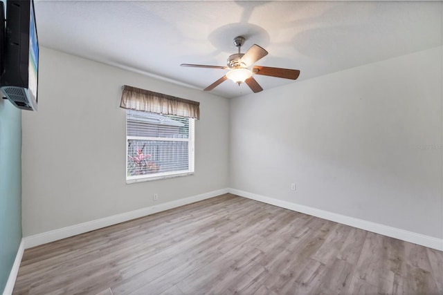 9016 30th St E, Parrish, FL 34219 - empty room featuring wood finished floors, baseboards, and a ceiling fan