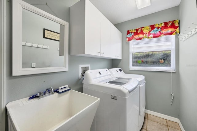 9016 30th St E, Parrish, FL 34219 - washroom featuring separate washer and dryer, cabinet space, baseboards, and light tile patterned floors