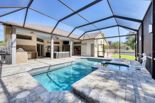 9016 30th St E, Parrish, FL 34219 - view of pool with an outdoor kitchen, a patio, a pool with connected hot tub, an outdoor hangout area, and glass enclosure