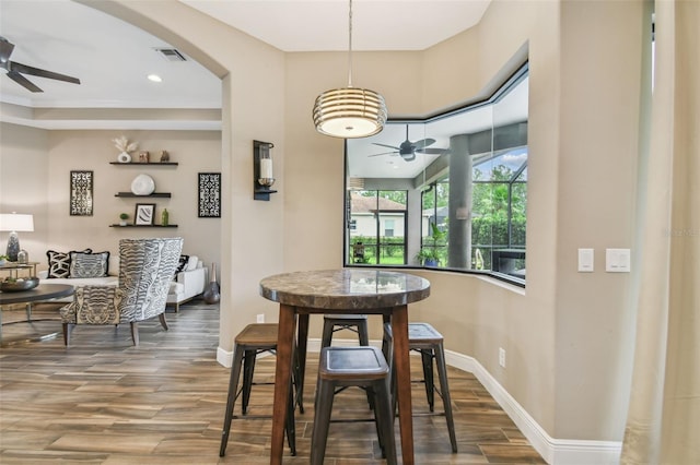 16246 26th St E, Parrish, FL 34219 - dining space with a ceiling fan, wood finished floors, baseboards, and arched walkways
