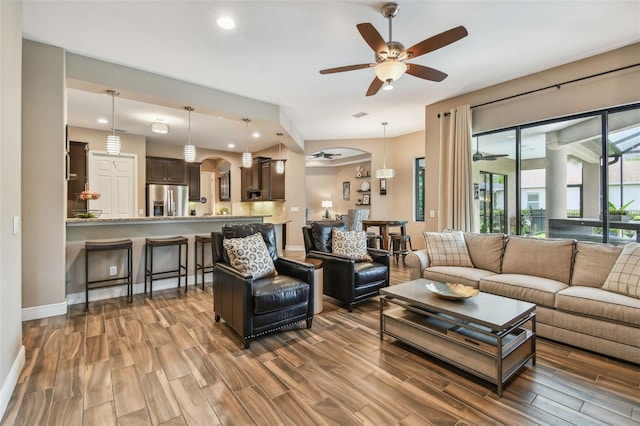 16246 26th St E, Parrish, FL 34219 - living area with wood finished floors, ceiling fan, baseboards, recessed lighting, and arched walkways
