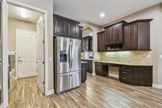 16246 26th St E, Parrish, FL 34219 - kitchen featuring stainless steel refrigerator with ice dispenser, arched walkways, dark brown cabinetry, light wood-type flooring, and recessed lighting