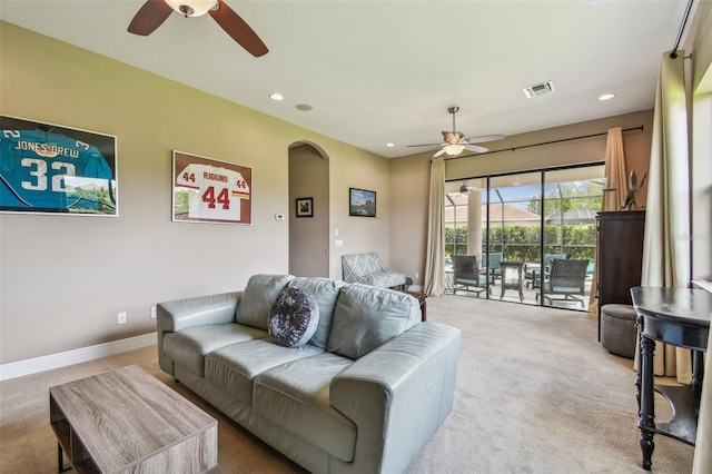 16246 26th St E, Parrish, FL 34219 - living room with ceiling fan, light colored carpet, arched walkways, recessed lighting, and baseboards