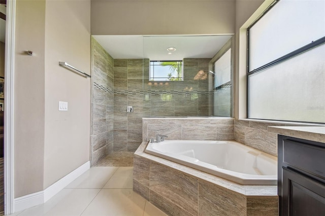 16246 26th St E, Parrish, FL 34219 - bathroom featuring a garden tub, a walk in shower, tile patterned flooring, and baseboards