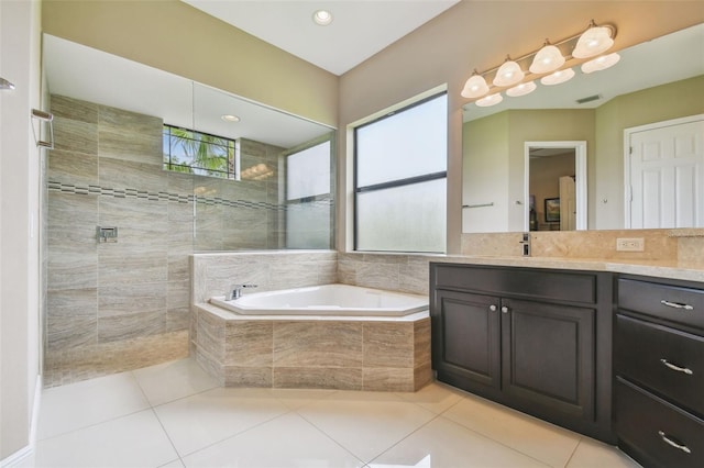 16246 26th St E, Parrish, FL 34219 - bathroom featuring vanity, a bath, tile patterned floors, and a tile shower