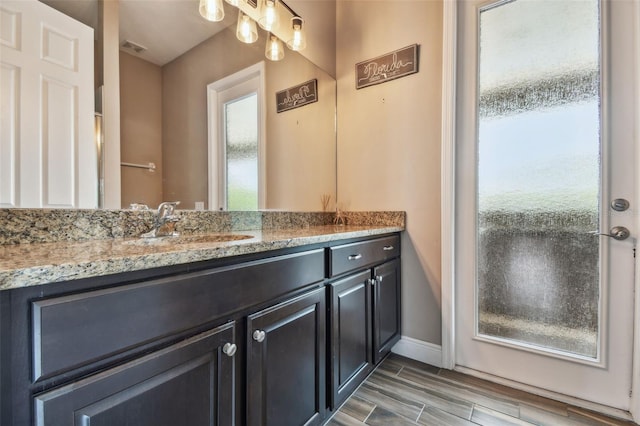 16246 26th St E, Parrish, FL 34219 - bathroom featuring vanity, baseboards, and wood finished floors