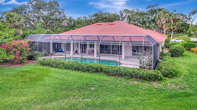 3388 Highlands Bridge Rd, Sarasota, FL 34235 - rear view of property with a tiled roof, a patio area, a lawn, an outdoor pool, and glass enclosure