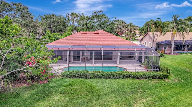 3388 Highlands Bridge Rd, Sarasota, FL 34235 - back of house with a tile roof, a patio area, a lawn, an outdoor pool, and a lanai