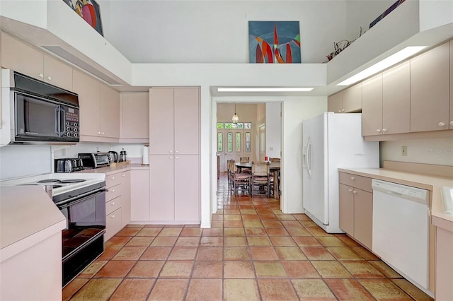 3388 Highlands Bridge Rd, Sarasota, FL 34235 - kitchen featuring black appliances, light countertops, and a high ceiling