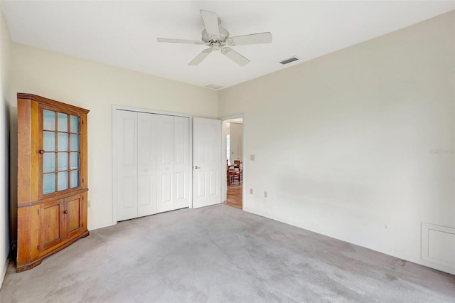 3388 Highlands Bridge Rd, Sarasota, FL 34235 - unfurnished bedroom featuring light colored carpet, a closet, and a ceiling fan