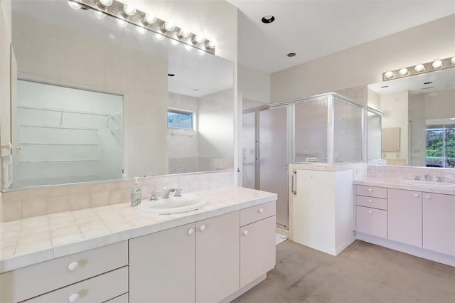 3388 Highlands Bridge Rd, Sarasota, FL 34235 - bathroom with a shower stall, two vanities, and a walk in closet